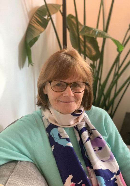A portrait of myself wearing a mint sweater and a flower flower pattern scarf